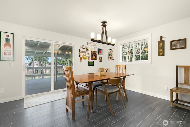 dining area featuring dark wood finished floors, a healthy amount of sunlight, and baseboards