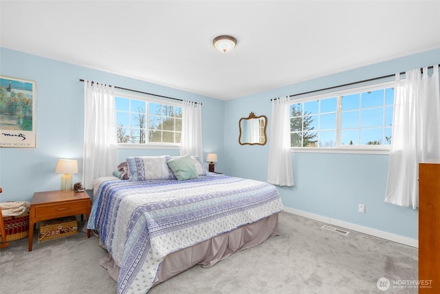 bedroom featuring visible vents, baseboards, and carpet