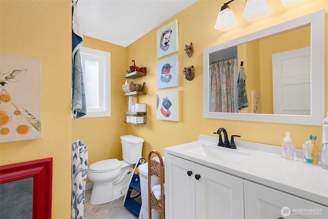 full bathroom with toilet and vanity