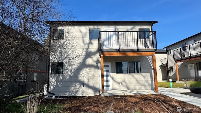 rear view of house featuring a balcony