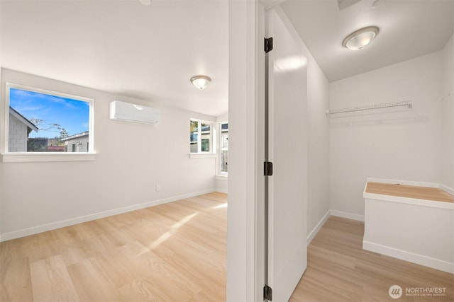 interior space featuring a wall mounted air conditioner and wood finished floors