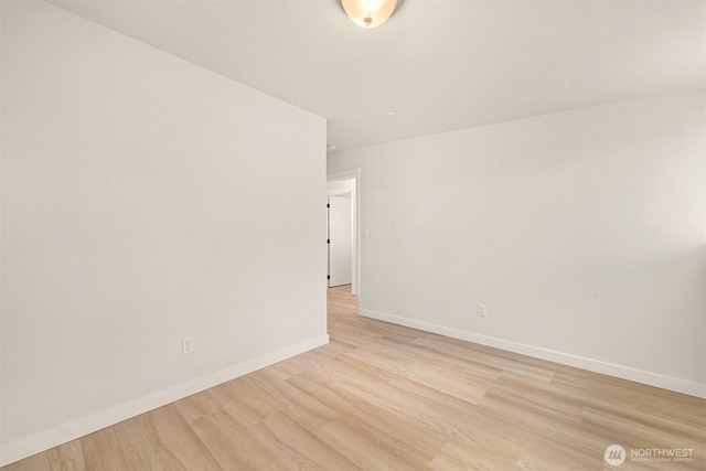 unfurnished room featuring light wood-style flooring and baseboards