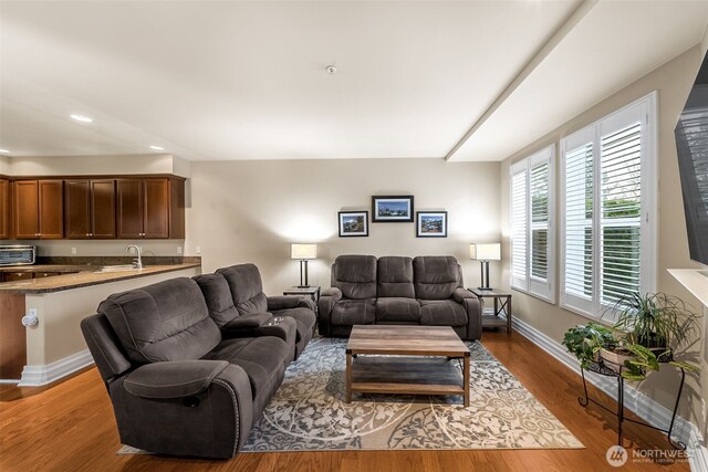 living room with recessed lighting, baseboards, wood finished floors, and a toaster