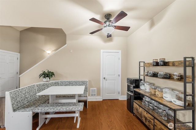 interior space with visible vents, baseboards, wood finished floors, and a ceiling fan