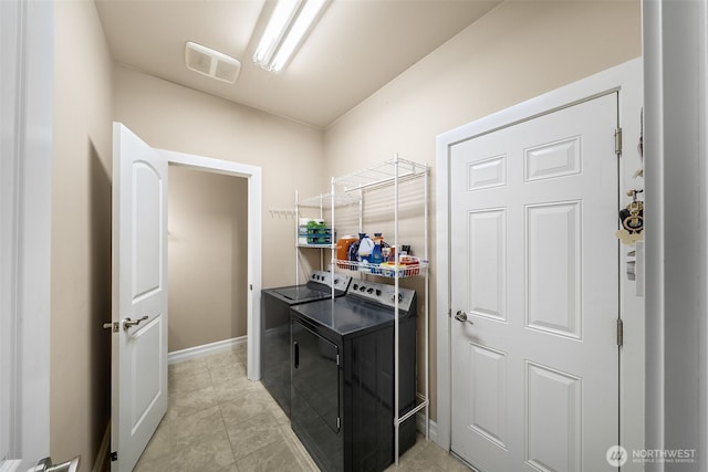 washroom with light tile patterned floors, laundry area, visible vents, and separate washer and dryer