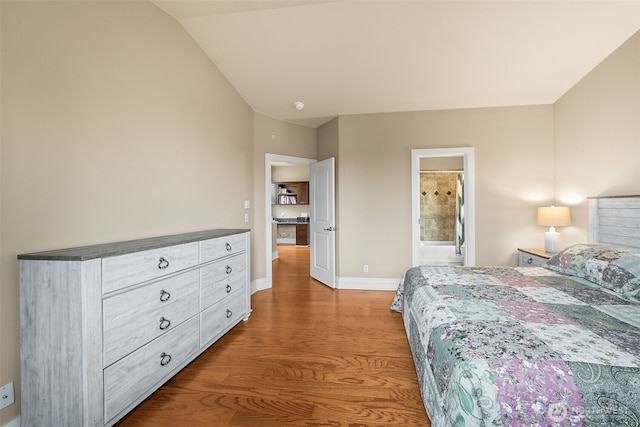 bedroom with baseboards, lofted ceiling, and wood finished floors