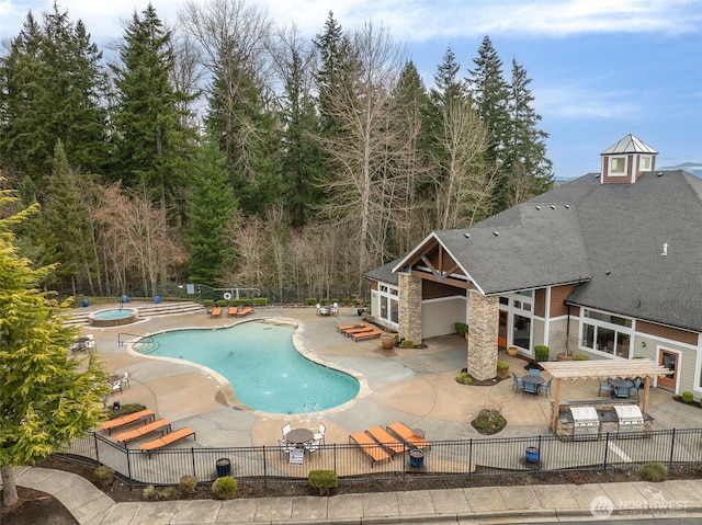 pool featuring a patio, a community hot tub, and fence