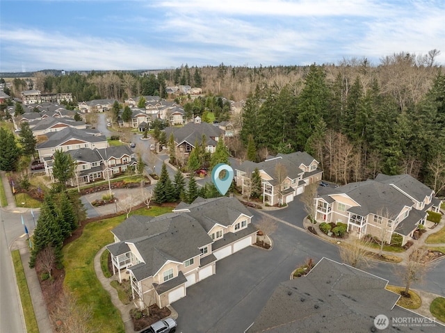 birds eye view of property with a forest view and a residential view