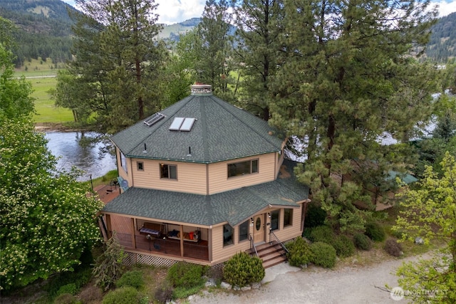 exterior space with a water and mountain view