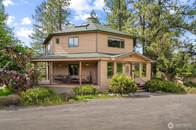 view of front of home featuring a porch and a shingled roof