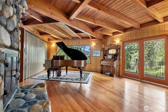 living area with hardwood / wood-style flooring, beamed ceiling, wood ceiling, and wood walls