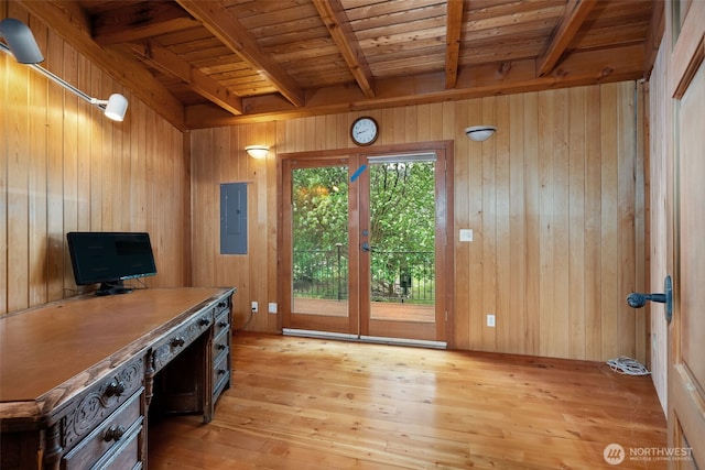 unfurnished office with electric panel, beam ceiling, and light wood-style floors