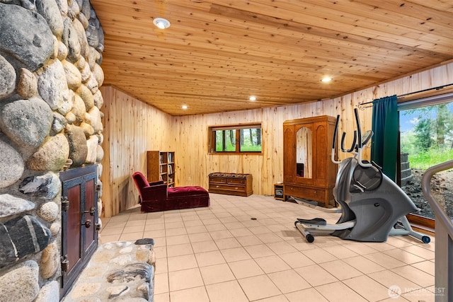 workout room with light tile patterned floors, wooden walls, wooden ceiling, and recessed lighting