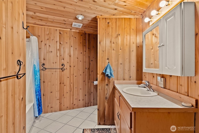 bathroom with vanity, wooden walls, visible vents, tile patterned floors, and wooden ceiling