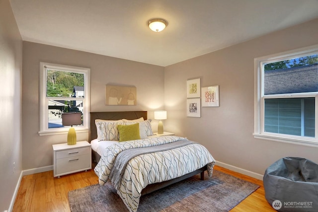 bedroom featuring baseboards and light wood-style floors