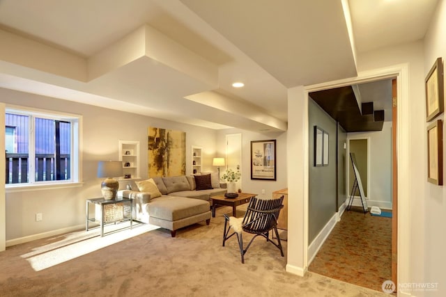 living room with recessed lighting, light colored carpet, and baseboards