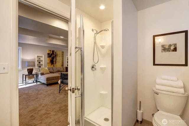 full bathroom featuring toilet and a shower stall