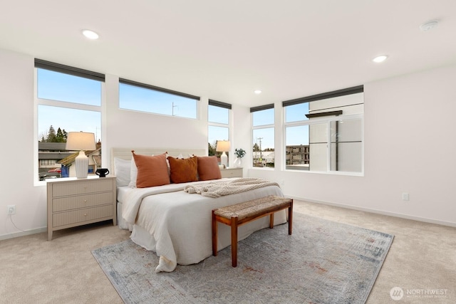 carpeted bedroom featuring recessed lighting and baseboards