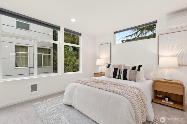 bedroom with visible vents, baseboards, a wall mounted air conditioner, carpet floors, and recessed lighting