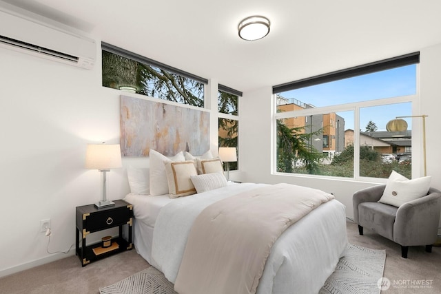 bedroom featuring baseboards, light colored carpet, and a wall mounted AC