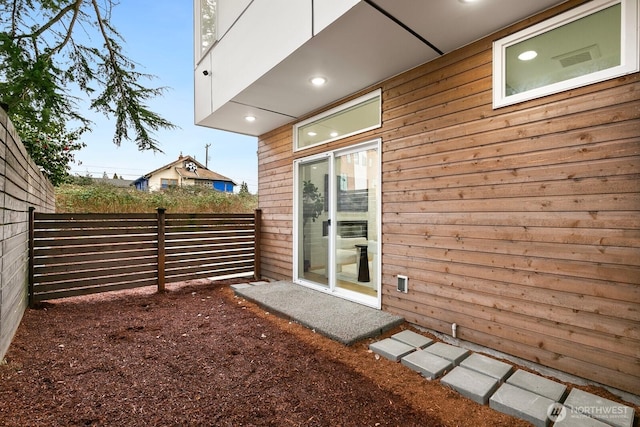 view of exterior entry featuring fence