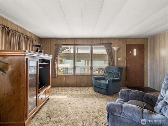 carpeted living room with wooden walls