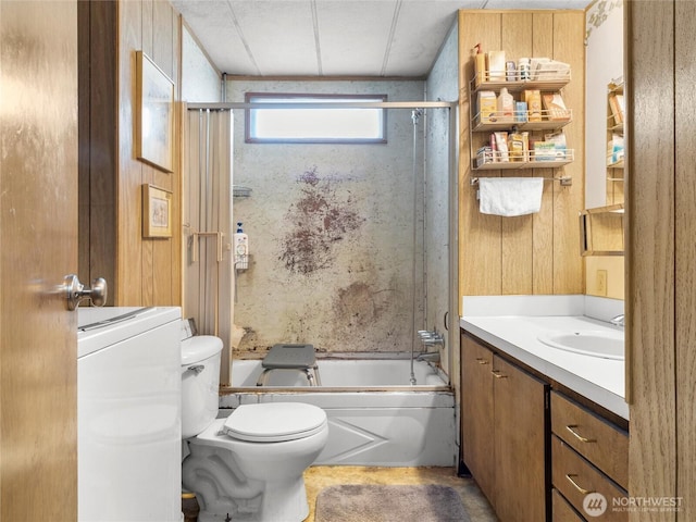 full bathroom with bath / shower combo with glass door, toilet, and vanity