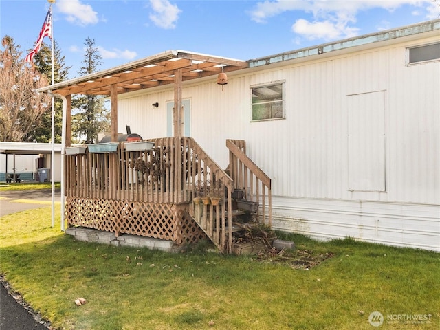 exterior space featuring a lawn and a wooden deck