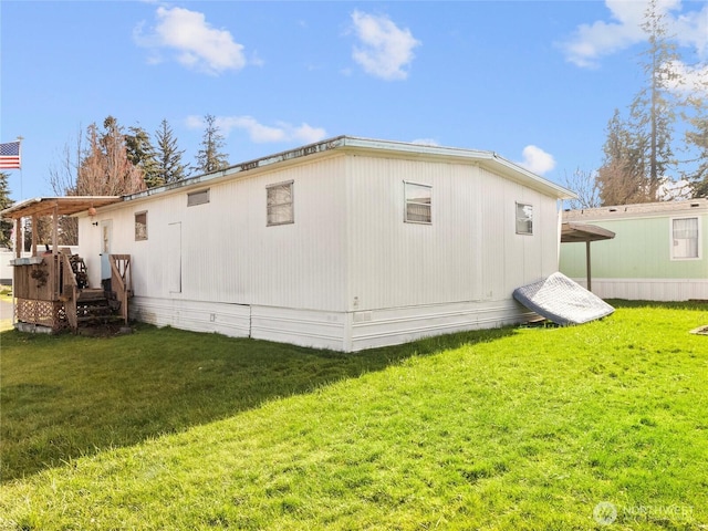 view of side of home with a lawn and a deck