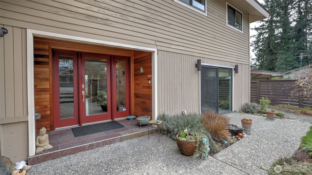 property entrance with french doors and fence