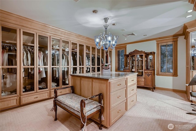 spacious closet with visible vents, a notable chandelier, and light colored carpet