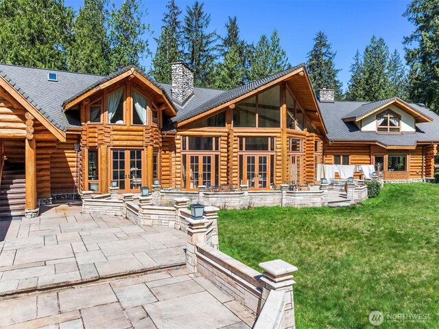 8100 428th Ave SE, Snoqualmie, WA 98065 - rear view of house with log siding, a patio area, french doors, and a chimney
