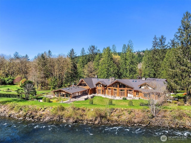 8100 428th Ave SE, Snoqualmie, WA 98065 - rear view of property featuring a water view, a chimney, a forest view, and a yard