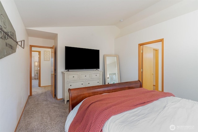 carpeted bedroom with baseboards and vaulted ceiling