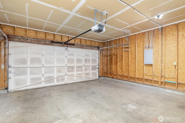 garage featuring electric panel and a garage door opener