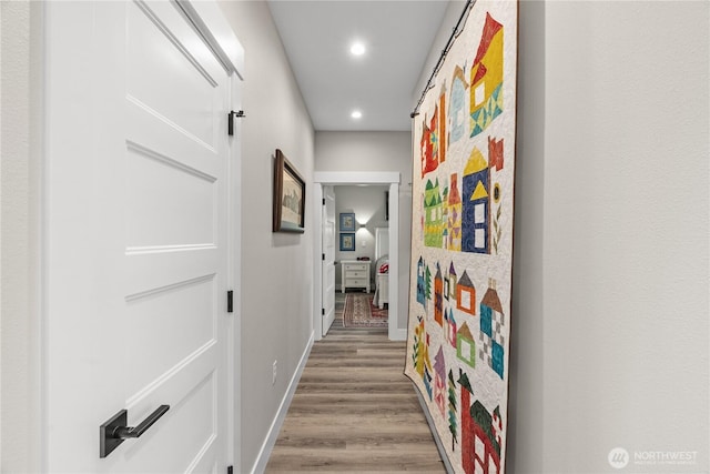 corridor featuring recessed lighting, baseboards, and wood finished floors