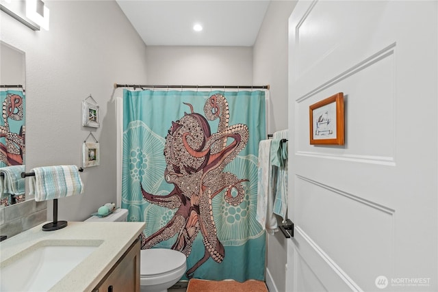 bathroom with a shower with shower curtain, toilet, and vanity