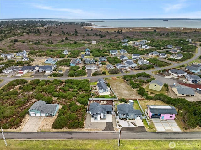 drone / aerial view with a residential view and a water view