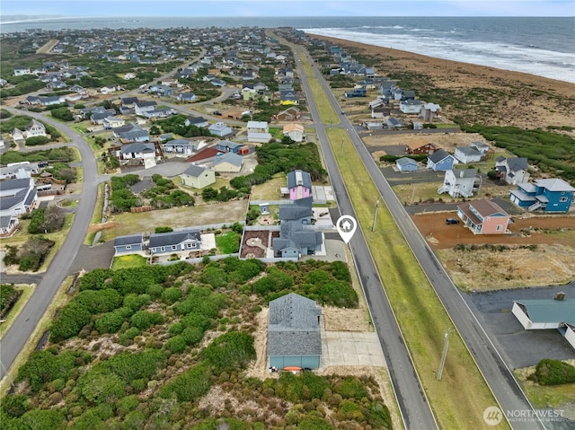 birds eye view of property featuring a residential view, a water view, and a beach view