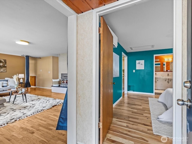 corridor with wood finished floors and baseboards