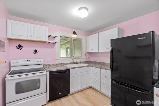 kitchen featuring a sink, light wood-type flooring, black appliances, and white cabinetry