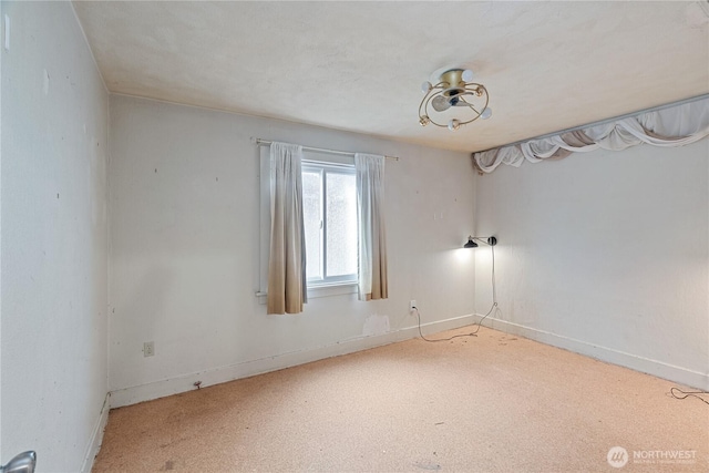 spare room with carpet flooring and baseboards