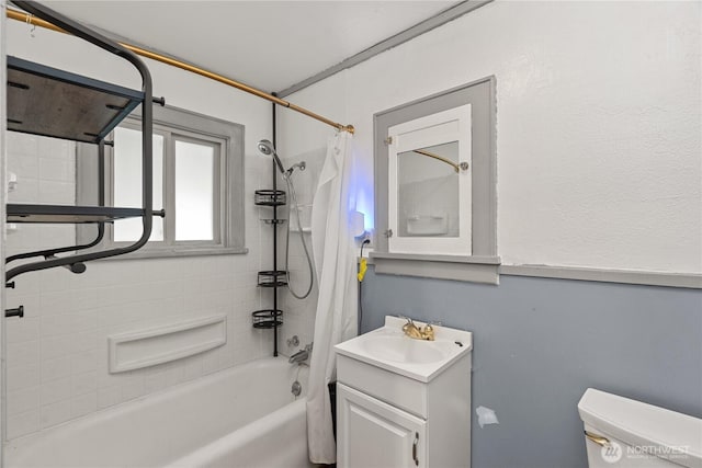 bathroom featuring vanity, toilet, and shower / tub combo with curtain