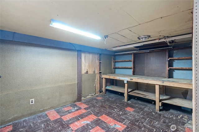 unfinished basement with a workshop area