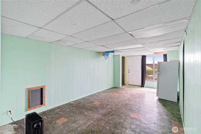 basement with a drop ceiling and visible vents