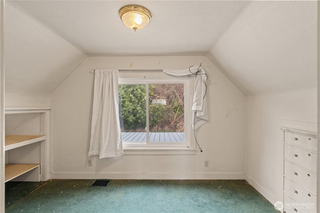 bonus room featuring lofted ceiling, carpet flooring, baseboards, and visible vents