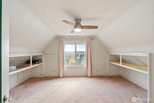 additional living space with a ceiling fan, carpet flooring, and vaulted ceiling