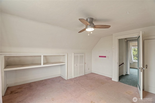 additional living space with baseboards, a ceiling fan, carpet, and lofted ceiling