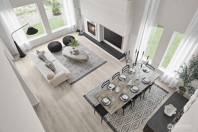 living area featuring a glass covered fireplace and wood finished floors