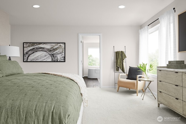 bedroom with recessed lighting, connected bathroom, baseboards, and light colored carpet